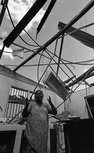 Woman in destroyed home, Nicaragua, 1979