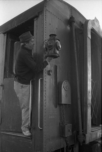 Train employee rings the bell, Mexico, 1983