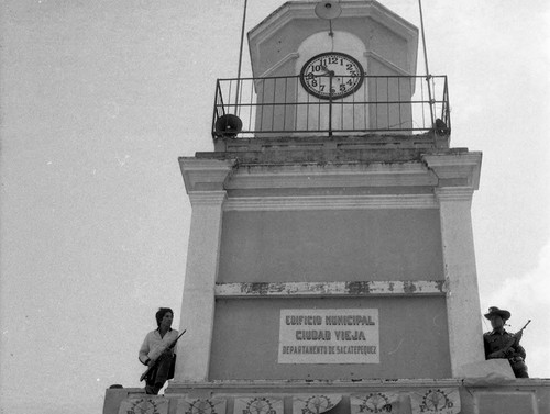 Armed men standing on a clock tower, Guatemala, 1982