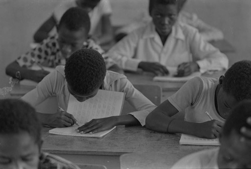 Student in a classroom writing on notebook, San Basilio de Palenque, ca. 1978