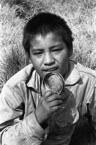 Child with lid near mouth, Mexico City, 1982