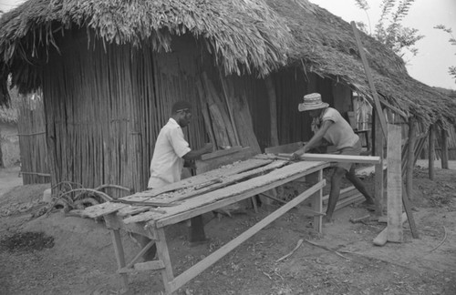 Two men working at a construction table, San Basilio de Palenque, 1977