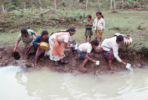 Guatemalan refugees collecting water at a River, Santiago el Vértice, 1983