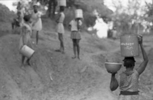 Women carry buckets from the river, San Basilio de Palenque, 1975