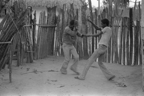 Boys boxing in front of a fence, San Basilio del Palenque, ca. 1978