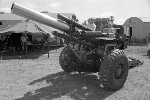 Boys on field artillery cannon, Pipestone County Fair, Minnesota, 1972