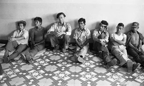 Men sitting against a wall, Estelí, 1980