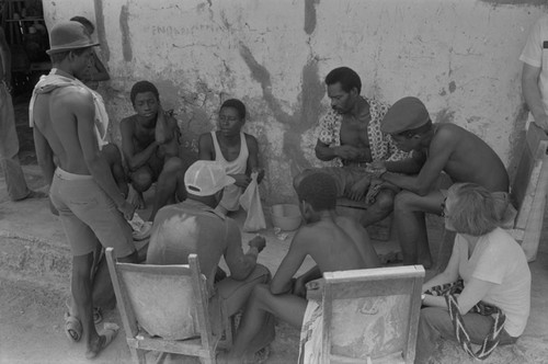 Nina S. de Friedemann watches men playing a game, San Basilio de Palenque, ca. 1978