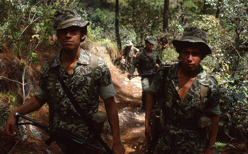 Two soldiers stand in a wooded area, Zaragoza, 1982