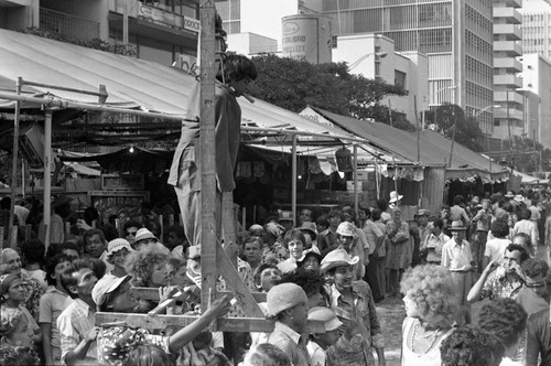 Young boy performing from a gallows, Barranquilla, Colombia, 1977