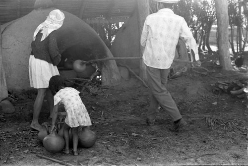 Man operating an oven, La Chamba, Colombia, 1975