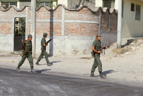 Soldiers patrolling on election day, San Salvador, El Salvador, 1982