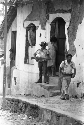 Paramilitary men guard town with rifles, Alegría, 1983