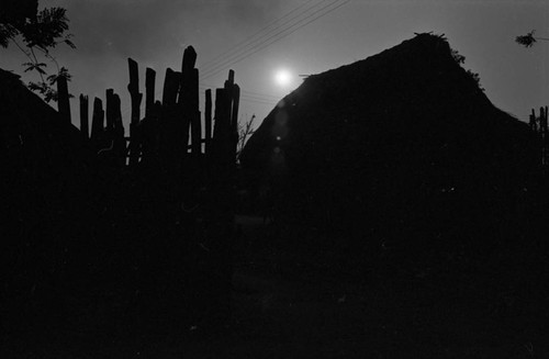 Fence and house at sunset, San Basilio de Palenque, ca. 1978