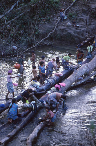 Guatemalan refugee women and children wash themselves and their clothes in the rive, Puerto Rico, 1983