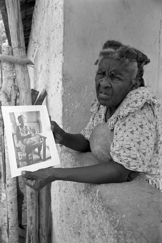 Woman holding a portrait, San Basilio de Palenque, 1977