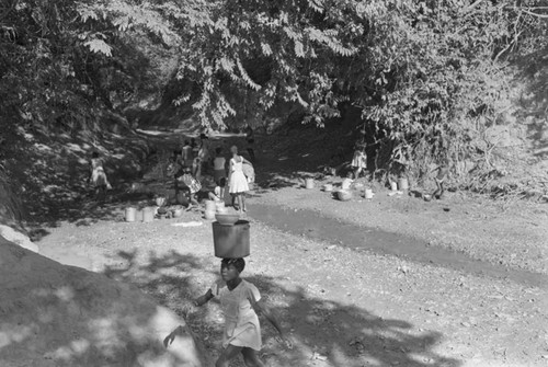 Girl collecting water at river, San Basilio de Palenque, ca. 1978