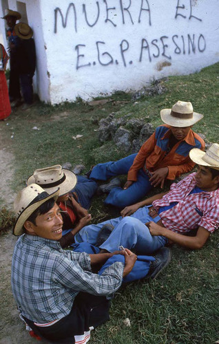 Mayan men near a graffiti wall, Chajul, 1982