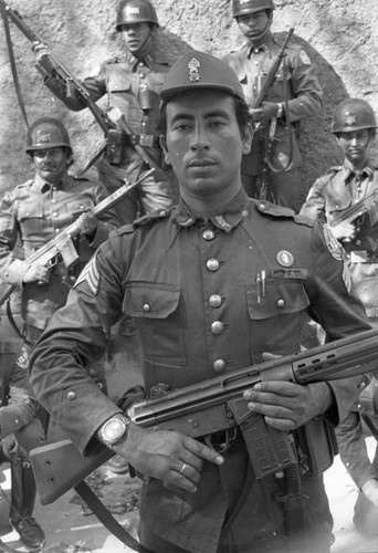 Armed National Guard squad posing in the street, Chalatenango, 1981