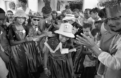 Dancer walking among a crowd, Barranquilla, Colombia, 1977