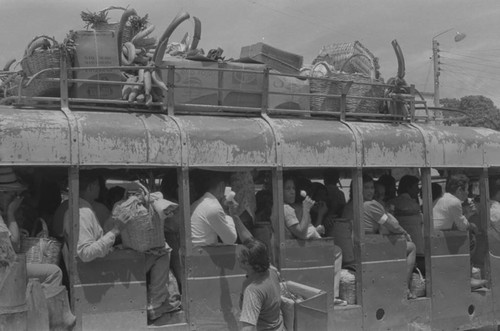 People riding the bus, La Chamba, Colombia, 1977