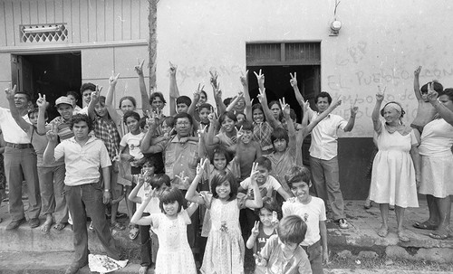 A group of people holding their fingers in victory signs, Nicaragua, 1979