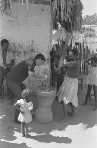 Richard Cross and woman grinding corn, San Basilio de Palenque, ca. 1978