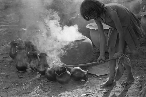 Girl with smoking clay jugs, La Chamba, Colombia, 1975