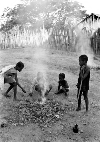 Group of children playing with small fire, San Basilio del Palenque, ca. 1978