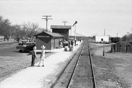 Groups of people wait at the "La Colorada" train station, Chihuahua, 1983