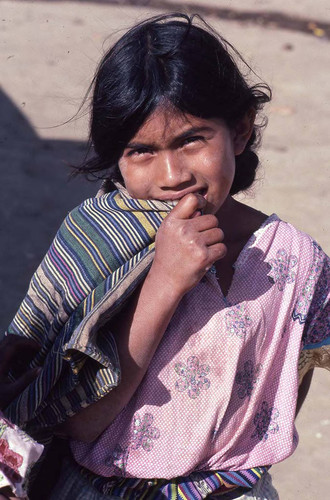 Portrait of a Mayan girl biting into her colorful-striped shawl, Chajul, 1982