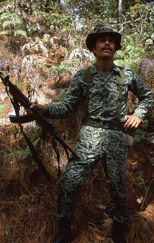 Armed soldier stands while on patrol, Guatemala, 1982