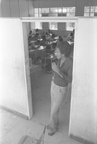 Teacher leaning on doorway, San Basilio del Palenque, ca. 1978