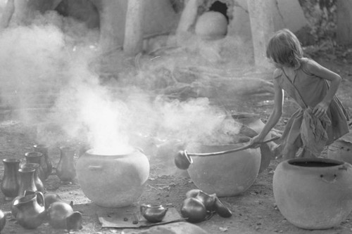 Girl with smoking clay jugs, La Chamba, Colombia, 1975