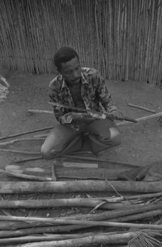 Man smoothing wood, San Basilio de Palenque, 1977