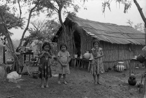 Refugee girls outside of a hut, Chiapas, 1983