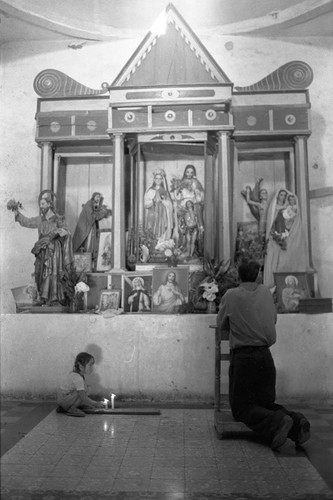 A girl and a man inside a church, Perquín, 1983