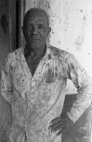 Man stands in front of a building, San Basilio de Palenque, 1975