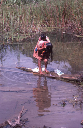 Guatemalan refugee washing her hair in the river, Cuauhtémoc, 1983