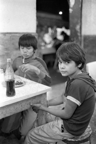 Two boys at a restrauant, Mexico City, 1982