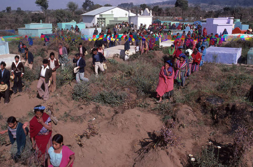 Mayan civilians walking through a cemetery, Patzún, 1982