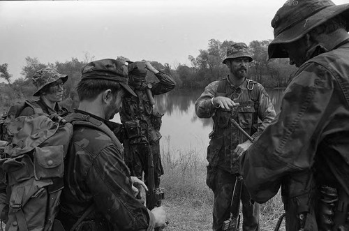 Survival school students converse with instructor, Liberal, 1982