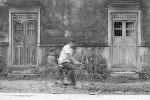 Man riding down the street, La Chamba, Colombia, 1975