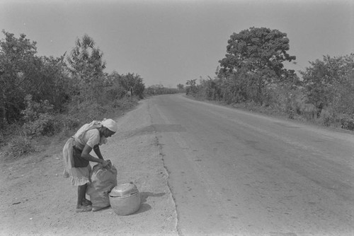 Woman setting up a selling stand by the road, Cartagena Province, ca. 1978