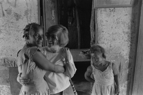 Nina S. de Friedemann hugging a woman,, San Basilio del Palenque, ca. 1978