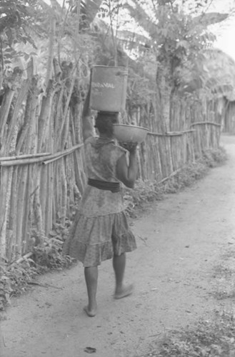 Woman with bucket on her head, San Basilio de Palenque, 1975