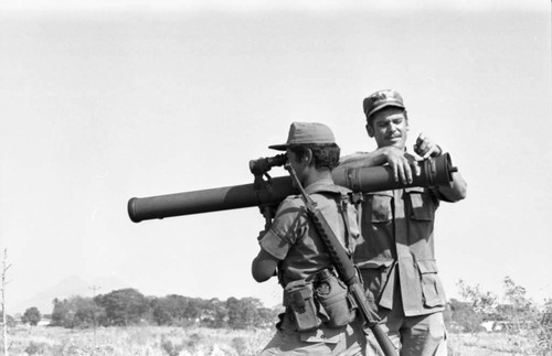 A U.S. military advisor training a Salvadoran soldier at Ilopango Military Base, Ilopango, 1983