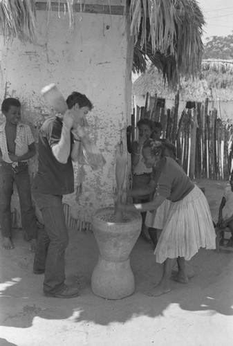 Richard Cross and woman grinding corn, San Basilio de Palenque, ca. 1978