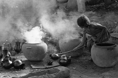 Girl with smoking clay jugs, La Chamba, Colombia, 1975