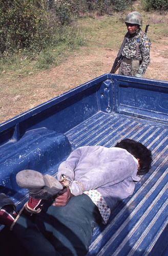 Hogtied man and a soldier, Guatemala, 1982